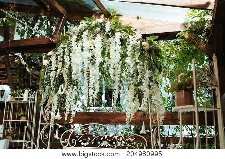 Wedding arch decorated with white hanging flowers