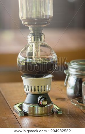 Close Up Of Siphon Vacuum, Coffee Cup And Siphon Vacuum Coffee Maker At Shop