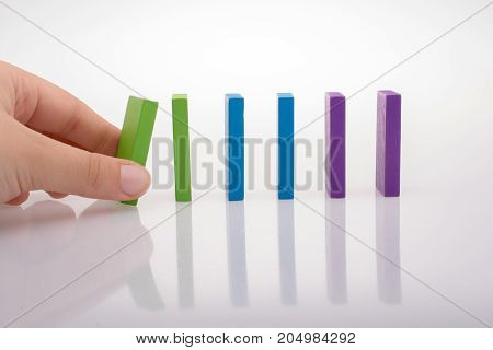 Colorful Domino Blocks in a line on a white background