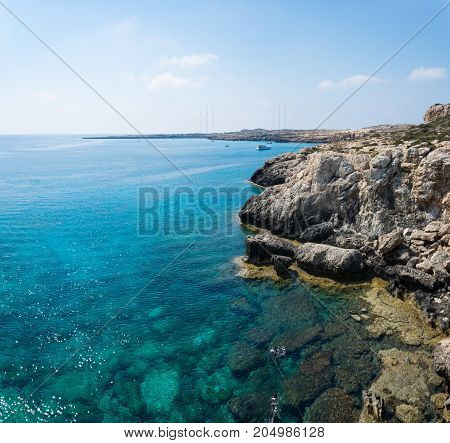 Sea caves of Cavo greco cape. Mediterranean sea landscape skyline