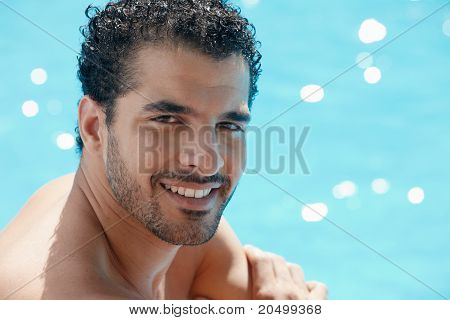 Young Man Sitting In Swimming Pool