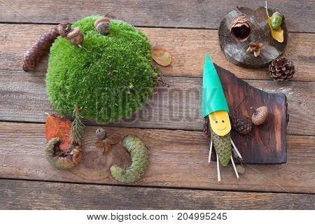 Funny figure made from pine cone and paper. Autumn decoration. Funny pinecone gnome.