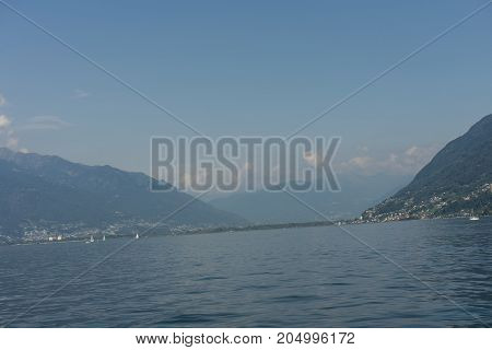 lago maggiore lake scenery with mountain water and cloudy sky in summer from boat