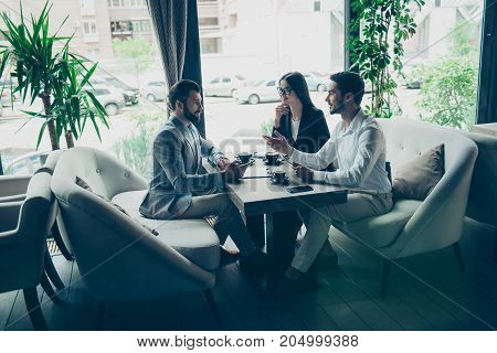 Young Business Partners Are Making A Deal With Lawyer About Their Business In A Fancy Restaurant`s T