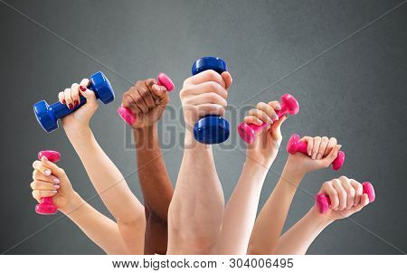 Man And Woman's Hand Holding Dumbbells In Green Backdrop