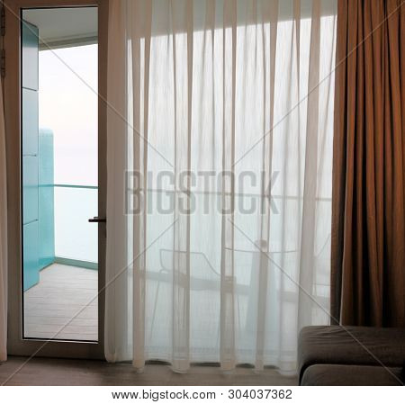 Fragment of Living room with glass door to balcony. Sea view.