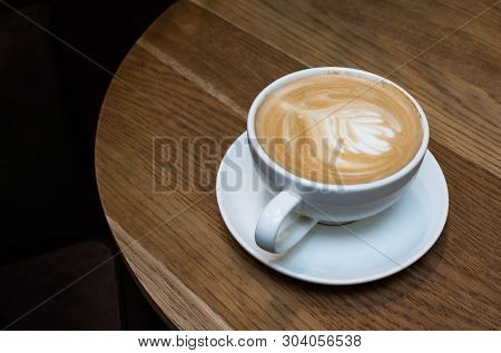 Coffee Latte Or Cappuccino In White Mug On Wooden Table, Dark Background.