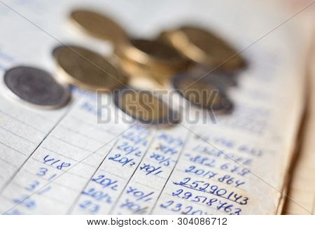 Hand-written Calculations And Coins. Bookkeeping (accounting). Economy. Financial Themes. Money Savi