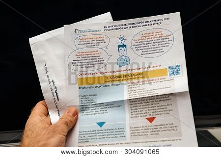 Paris, France - Apr 9, 2019: Man Reading Holding La Declaration Des Revenus Income Statement Instruc