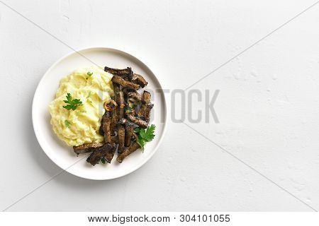 Mashed Potatoes With Roasted Beef Liver On White Plate Over Stone Background With Copy Space. Pieces