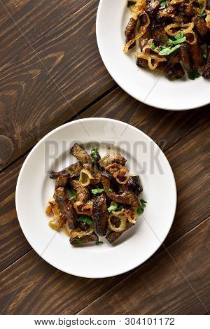 Fried Beef Liver With Onion On Plate Over Wooden Background. Pieces Cooked Liver (offal) From Beef. 