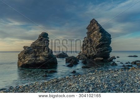 Nerja, Malaga, Andalusi, Spain - February 7, 2019: Molino Beach, Small Stone Beach With Two Large Ro