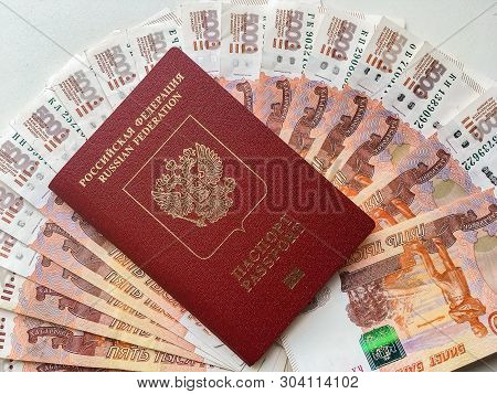 Russian Money And Passport On A Gray Background, Close-up