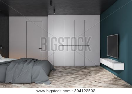 White And Blue Bedroom With Tv And Wardrobe