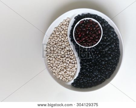 Yin Yang Of Black White Brown Beans On A Round Plate