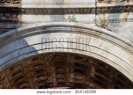 The Arch Of The Gate Of Hadrian. Hadrians Gate, Antalya Landmark. Ancient Construction Of The Gate O