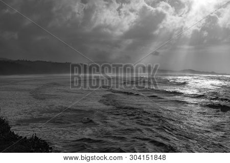 The Dramatic And Rugged Orgeon Coastline, Shot In Black And White To Add Drama, Shafts Of Light Comi