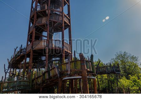 Wooden Observation Tower With Winding Staircase On Top Of Mountain On Sunny Day With Blue Sky.