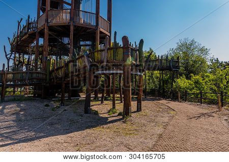 Wooden Observation Tower With Winding Staircase On Top Of Mountain On Sunny Day With Blue Sky.
