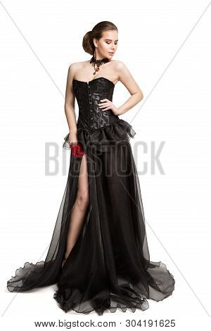 Fashion Model In Black Corset Dress Holding Red Rose Flower, Beautiful Woman In Long Gown, Isolated 