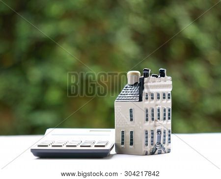 Property House With Calculator, Concept For Real Estate Or Mortgage And House Finance Or Loan