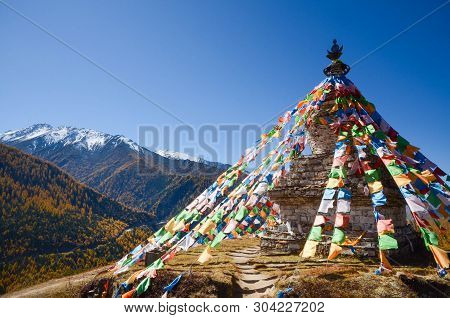 Colorful Tibetan Flags And Snow Mountain At Siguniang Scenic Area In Autumn Season,chengdu, China.