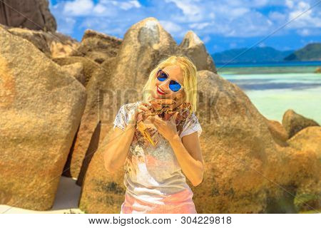 Tourism In Seychelles, Africa, Indian Ocean. Tourist Woman Holding An Ocypode Ceratophthalmus Or Gho