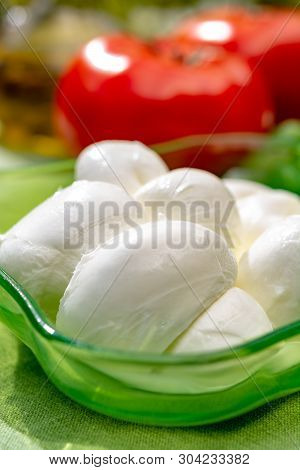 Twisted To Form A Plait Treccia Mozzarella Italian Soft Cheese Served With Fresh Basil And Tomatoes