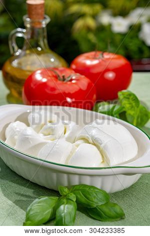 Twisted To Form A Plait Treccia Mozzarella Italian Soft Cheese Served With Fresh Basil And Tomatoes