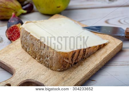 Piece Of French Cheese Tomme De Brebis Made From Sheep Milk Served As Dessert With Fresh Figs And Pe