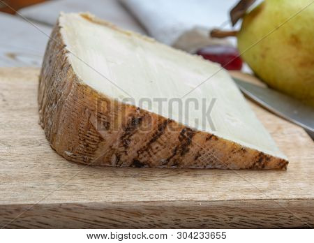 Piece Of French Cheese Tomme De Brebis Made From Sheep Milk Served As Dessert With Fresh Figs And Pe
