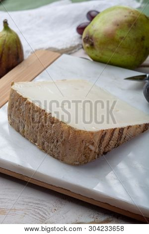 Piece Of French Cheese Tomme De Brebis Made From Sheep Milk Served As Dessert With Fresh Figs And Pe