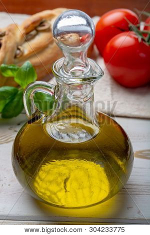 Virgin Natural Olive Oil Is Glass Bottle, Served With Traditional Mediterranean Food