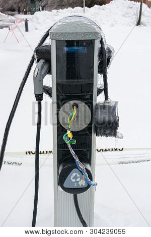Ev Charging Station In Disrepare. Brocken Charging Station In Extreme Weather Conditions. Ice Covere