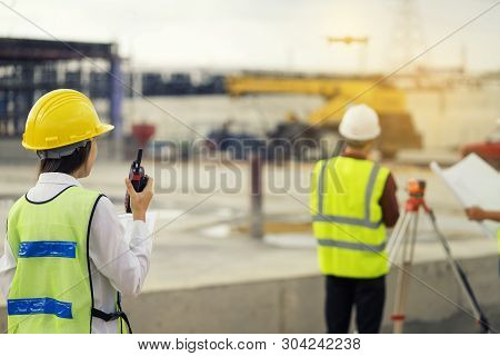 Foreman 3 People Are  See A Blueprint About The Factory Building Structure On The Job Site.foreman, 