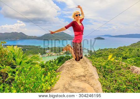 Praslin, Seychelles Freedom Woman Jumping. Joyful Happy Tourist Jumper At Lookout Of Island After Hi