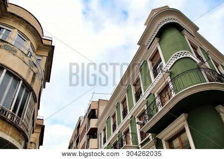 Old Colorful And Majestic Tiled Facades With Vintage Streetlight In Elche, Alicante, Spain. El Raval