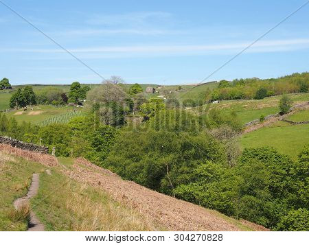 A Narrow Walking Path On High Moorland Surrounded By Pasture With Stone Walls Above Crimsworth Dean 