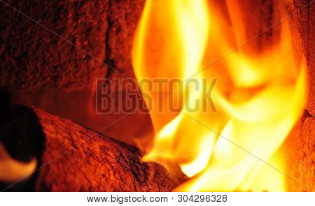 Wooden Biobriquet Burning In Fireplace Covered With Chamotte