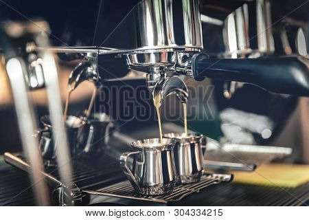 Making Coffee In A Professional Coffee Machine In The Cafeteria In The Iron Mugs.