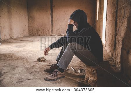 Men Who Show Stress And Loneliness, Homeless Man Drug  Addict Sitting Alone And Depressed  At An Aba