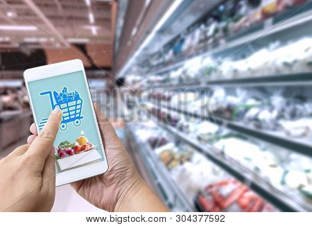 Online Grocery Shopping Concept: Woman Hand Holding Smart Phone For Ordering Food Onscreen With Icon