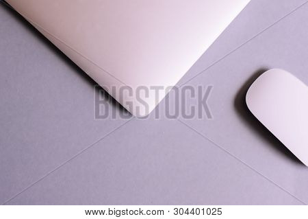 Laptop And Wireless Mouse On Lilac Table. Top View, Flat Lay.