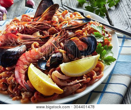 Close-up Of Spanish Fideua, A Noodle Paella With King Prawns, White Fish Meat, Calamari, Mussels Ser