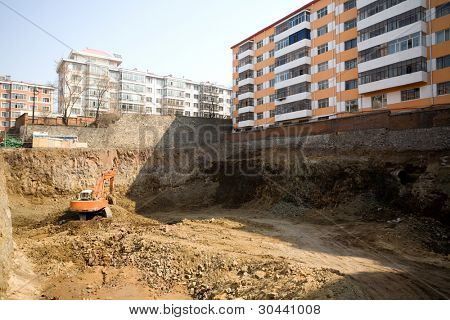 City.Workplace.Trench of a new building.Tractor Excavator.