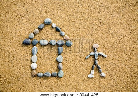 Pictogram house & henkilö pebble hiekalle.