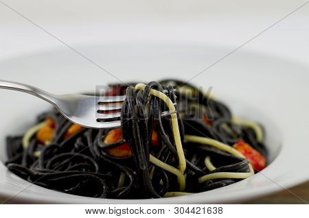 Italian Black Spaghetti, Alla Veneziana, With Grilled Prawns And Dried Tomatoes. With Olive Oil, Gar