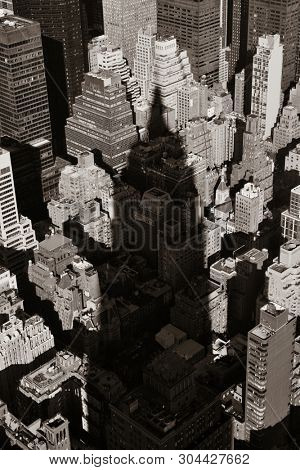 New York City - SEP 11: Empire State Building shadow over urban buildings on September 11, 2015 in New York City. With 8.5M, it is the is the most populous city in the United States.