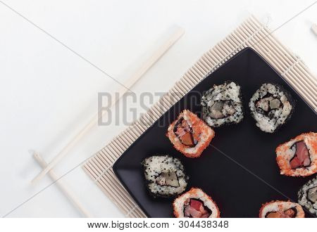 Different Types Of Maki Sushi On A Black Plate