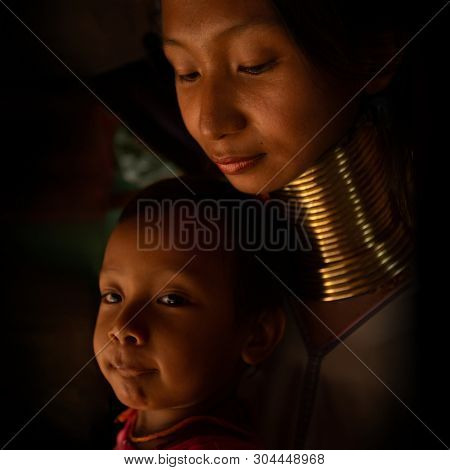 CHIANG MAI, TAILAND - APRIL 22, 2016: A portrait of a family from Kayan Lahwi tribe known for wearing neck rings, brass coils to extend the neck. Kayan, Red Karen (Karenni).